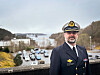 Thomas Gjesdal fra Sjøforsvaret står foran en fjord med biler og landskap i bakgrunnen.